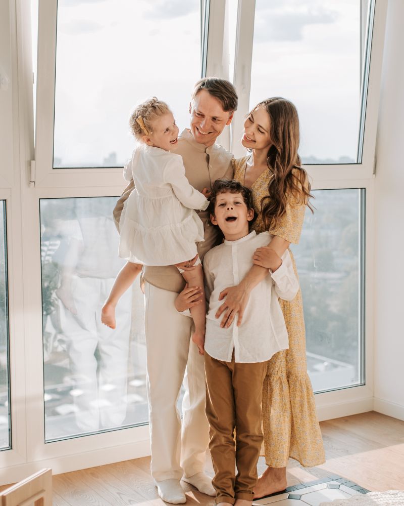 Family of 4: mother and father with 2 children, in home