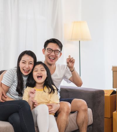 Family of 3 excited about new house holding up keys