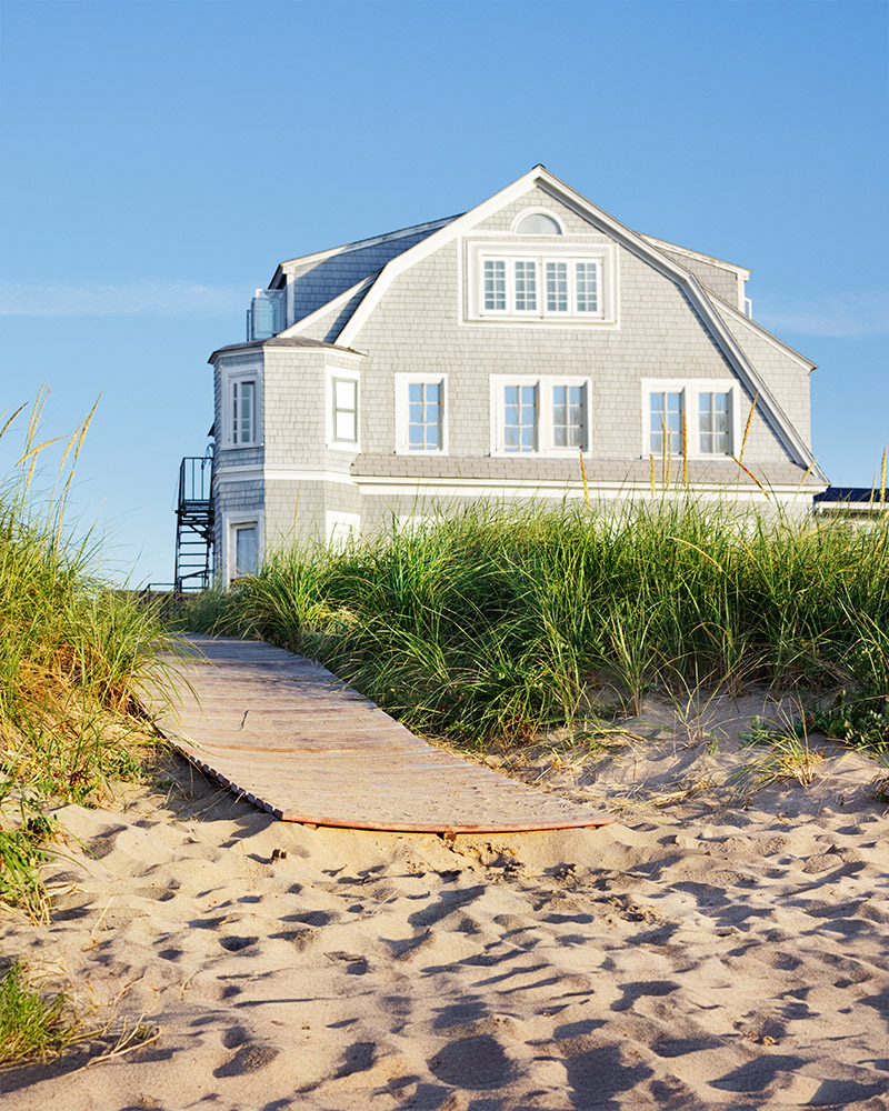 Couple standing in front of new house with keys